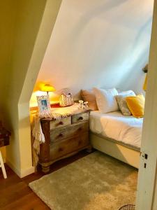 ein Schlafzimmer mit einem Bett und eine Kommode mit einer Lampe in der Unterkunft Charming countryhouse near Amsterdam in Abcoude + 12 Fotos