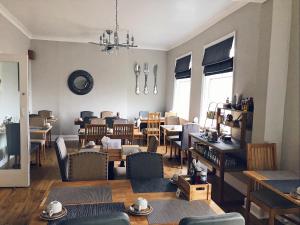 a living room with tables and chairs and a dining room at The Selomar in Scarborough