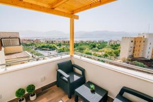 a balcony with two chairs and a table at The suite in Eilat
