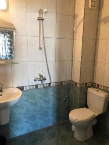 a bathroom with a toilet and a sink at Хотел Милев in Kiten +24 photos