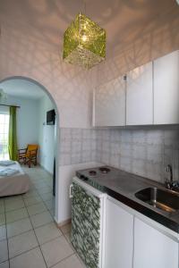 a kitchen with a sink and a counter top at Bella Casa Studios by Imagine Lefkada in Lefkada Town