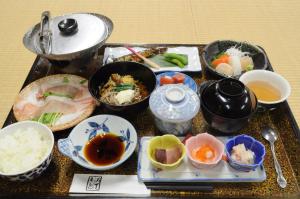 a table with various dishes of food on it at Izumi-so in Gero