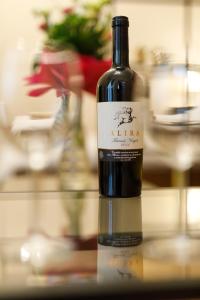 a bottle of wine sitting on a table at Stylish Flat in the Heart of Historical Center in Timişoara