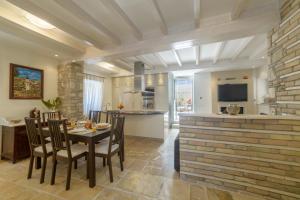a kitchen and dining room with a table and chairs at Pithari House in Corfu