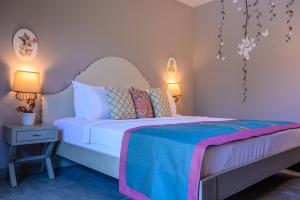 a bedroom with a white bed with a blue blanket at Villa Rustica Hotel in Gundogan +35 photos