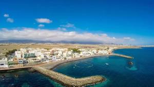 an aerial view of a beach with buildings and the water at POZO STYLE in Pozo Izquierdo