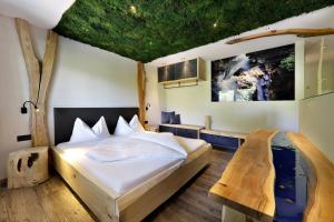 a bedroom with a bed in a tree themed room at Hotel Ratschingserhof in Racines