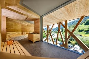 a large room with a large window and a sauna at Hotel Ratschingserhof in Racines