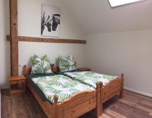 a bedroom with a wooden bed in a room at Ferienwohnung Hof Freimann in Eberhardzell