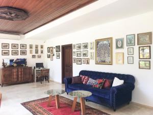 a living room with a blue couch and a table at The Ninova in Antalya +16 photos