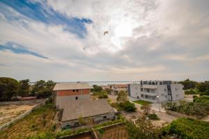 a bird flying in the sky over a city at Apartman Eva in Vrsi