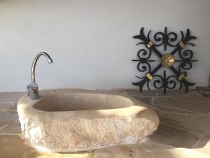 a stone bath tub with a faucet in a room at Zavala-Lighthouse in Zavala
