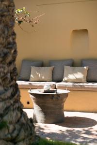 a couch with pillows and a table in a yard at Vila Joya in Albufeira