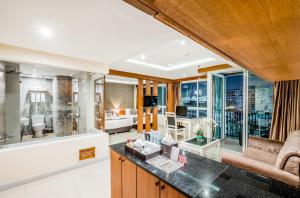 a living room with a view of a city at 247 Boutique Hotel in Pattaya Central