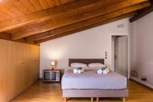 a bedroom with a large bed and a wooden ceiling at Moraitis Mansion in Corfu