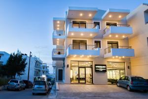 a building with cars parked in front of it at Aesthetic Apartments in Karpathos Town