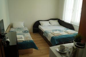 Guest House Di Mare في ابزور: غرفة صغيرة بسريرين وطاولة