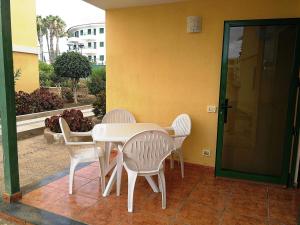 a white table and chairs on a patio at Apartamento Pepe in Playa del Ingles