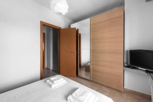 A television and/or entertainment centre at Nikiti Maisonette on the beach by Luxlikehome