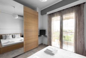 A bed or beds in a room at Nikiti Maisonette on the beach by Luxlikehome