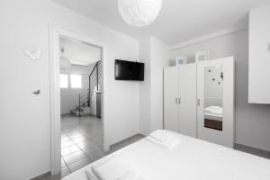 A bed or beds in a room at Nikiti Maisonette on the beach by Luxlikehome