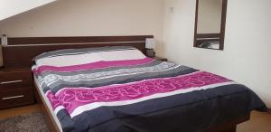 A bed or beds in a room at Fortuna Bansko