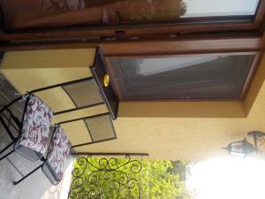 a window on the side of a building with chairs at Pensiunea Ruxandra la 100 m de Aqua Park Venus in Baile Unu Mai
