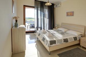 A bed or beds in a room at Lighthouse Luxe Estate Apart & Villas