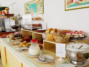 a bakery counter with various pastries and other foods at Hotel Ossidiana Stromboli Center in Stromboli