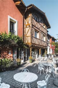 a building with tables and chairs in front of a building at Hotel Zubieta in Lekeitio +32 photos