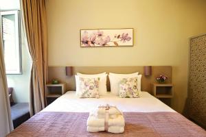a bedroom with a bed with flowers on it at Sofia Apartment in old Tbilisi in Tbilisi City