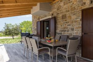 ein Esszimmer im Freien mit einem Tisch und Stühlen in der Unterkunft Villa Luka in Brtonigla