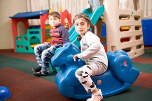 a boy and a girl playing in a playground at Yiwu Ocean Hotel - Original Best Western Premier Ocean Hotel in Yiwu
