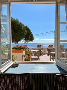 a room with a large window with a view of the ocean at Albergo Miramare in Bergeggi