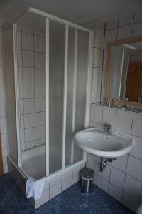 
a bathroom with a sink, toilet, and bathtub at Hotel am Bahnhof in Waren
