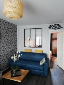 a living room with a blue couch and a table at L'ENTRE 2 COTES in Le Tréport +105 photos