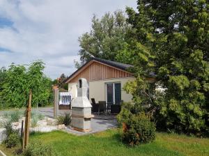 a small house with a statue in front of it at Haus Skye in Großenbrode