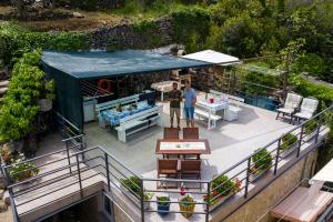 two people standing on the balcony of a house at Apartments and rooms Roberto B. in Valun