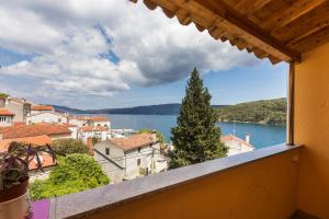 a view from a balcony of a town and a lake at Apartments and rooms Roberto B. in Valun