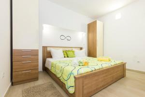 a bedroom with a large bed in a room at Apartments and rooms Roberto B. in Valun