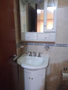 a bathroom with a sink and a mirror at MAU-MAR in Colón