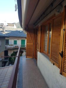 a balcony of a house with wooden doors at Casa Cippilippi in Saint Vincent