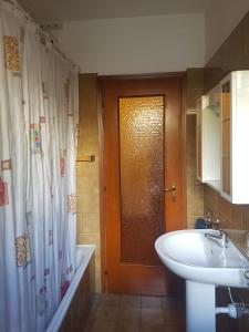 a bathroom with a sink and a shower curtain at Casa Cippilippi in Saint Vincent