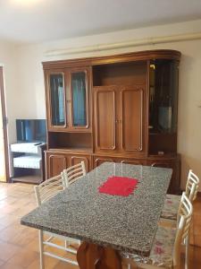 a dining room table with a red napkin on it at Casa Cippilippi in Saint Vincent