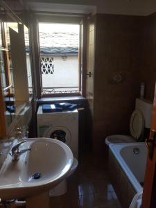 a bathroom with a sink and a washing machine at Casa Cippilippi in Saint Vincent