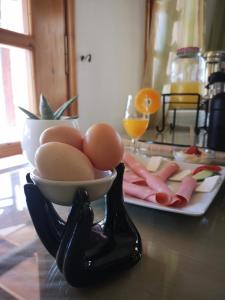 a table with a bowl of eggs and meats on a tray at Dimitris Villa Hotel in Matala