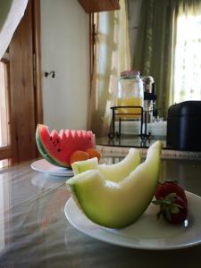 a plate of fruit sitting on a table at Dimitris Villa Hotel in Matala