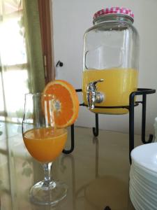 a glass of orange juice next to a jar of orange juice at Dimitris Villa Hotel in Matala