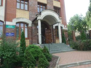 a brick building with a door and stairs in front at Pokoje Gościnne Centrum Kultury Prawosławnej in Białystok