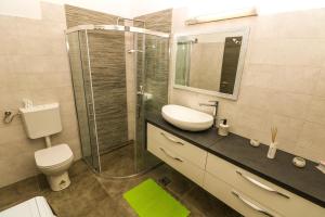 a bathroom with a toilet and a sink and a shower at Apartments Andrea in Baška